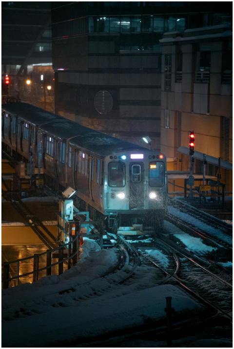 A train traveling in the snowy streets of Chicago
