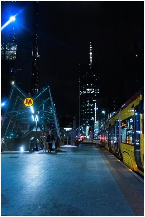 A vibrant urban night scene showing the illuminate