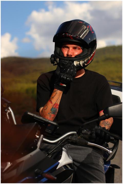 Biker on a motorcycle with helmet enjoys scenic ou