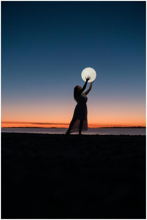 A serene scene of a woman silhouetted against a su