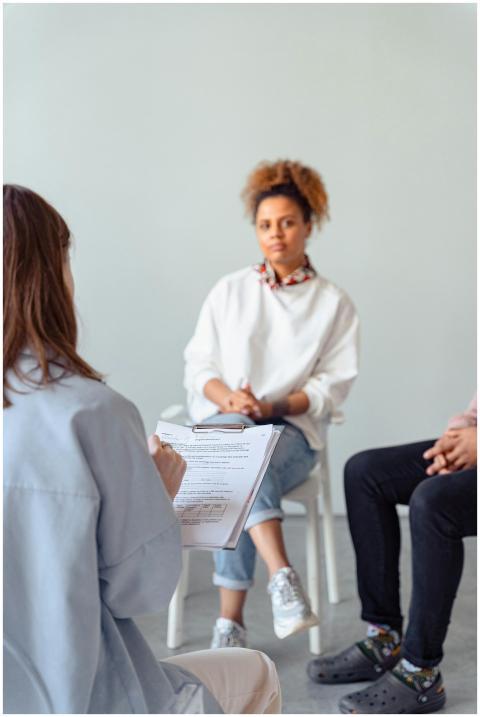 Counselor and diverse woman in a therapy session d