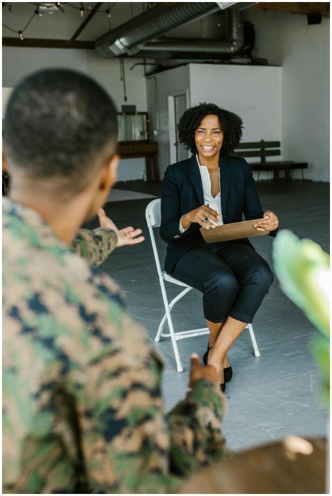 A therapist speaking with a military veteran to pr