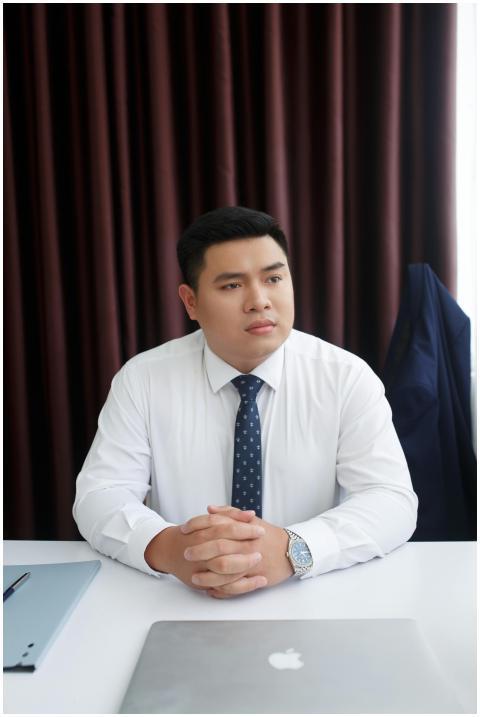 Businessman in white shirt and tie sitting at desk
