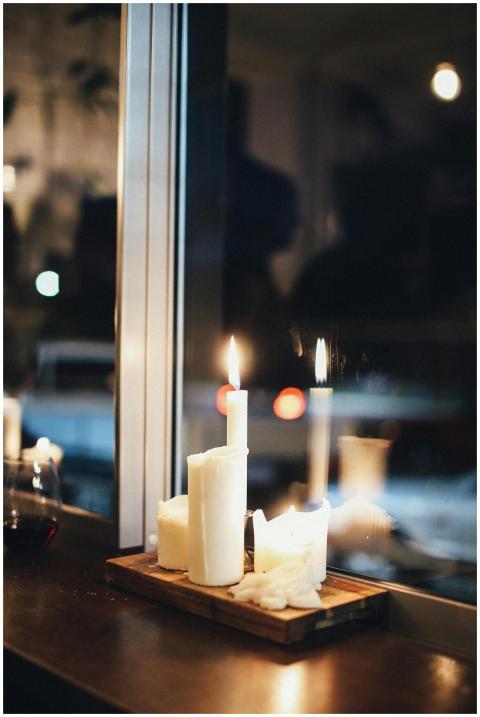 Warm candlelight setting by the window creating a