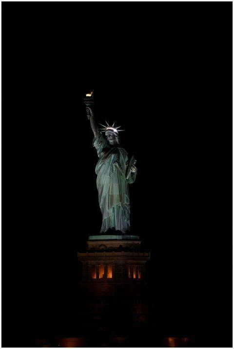 Stunning night view of the Statue of Liberty illum