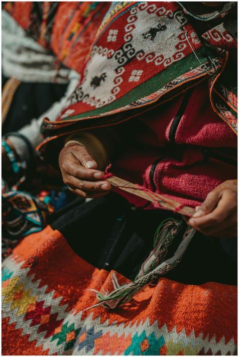 Close-up of Peruvian artisan weaving colorful text