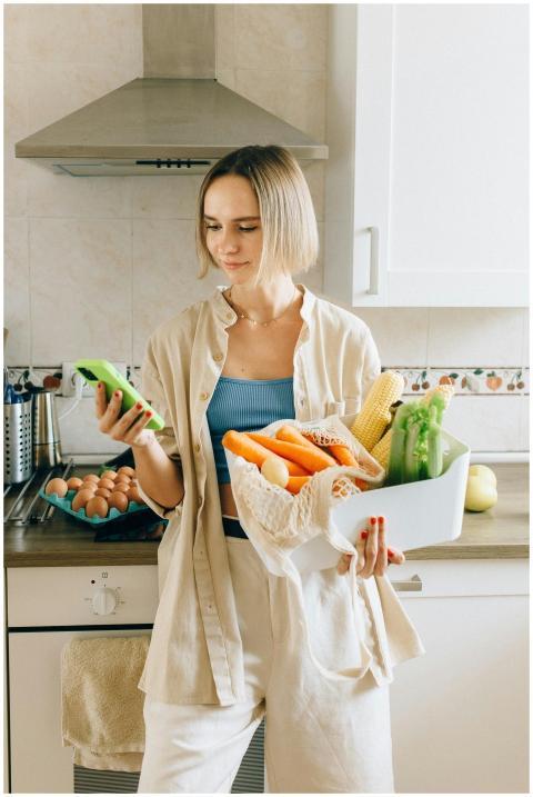 Woman in a modern kitchen holding fresh vegetables
