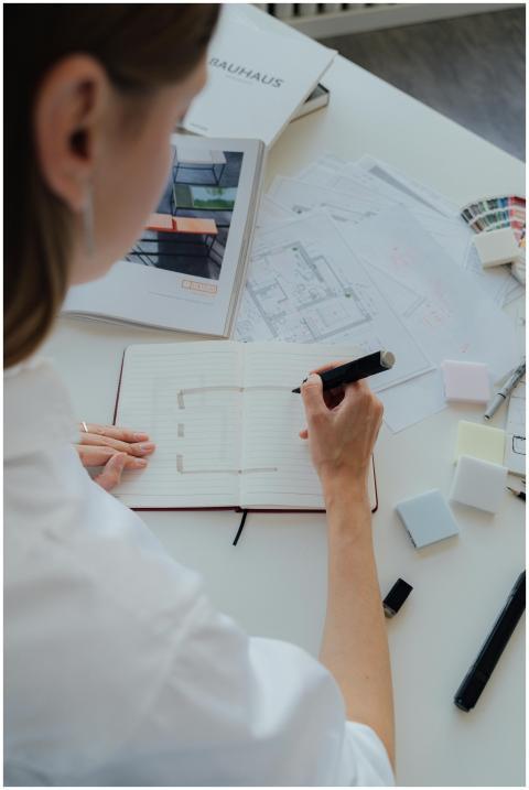 Interior designer sketching a floor plan with arch