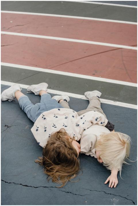 A serene moment of two children lying on a colorfu