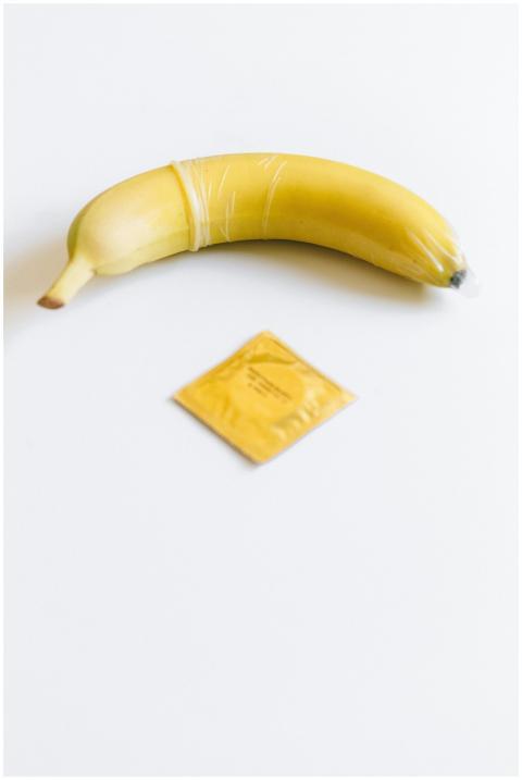 Conceptual image of a banana with a condom for saf