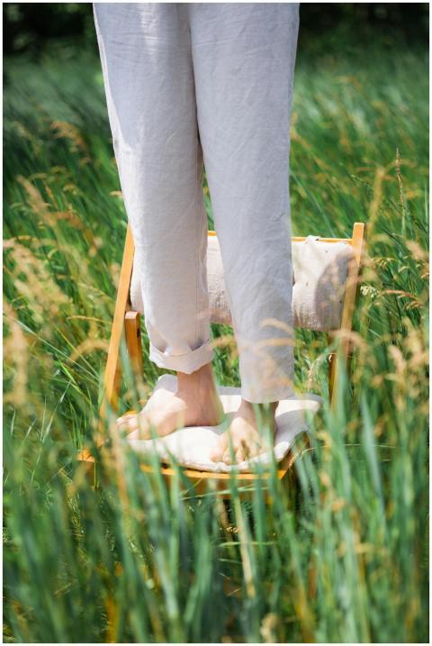Barefoot person standing on a chair in a sunny sum