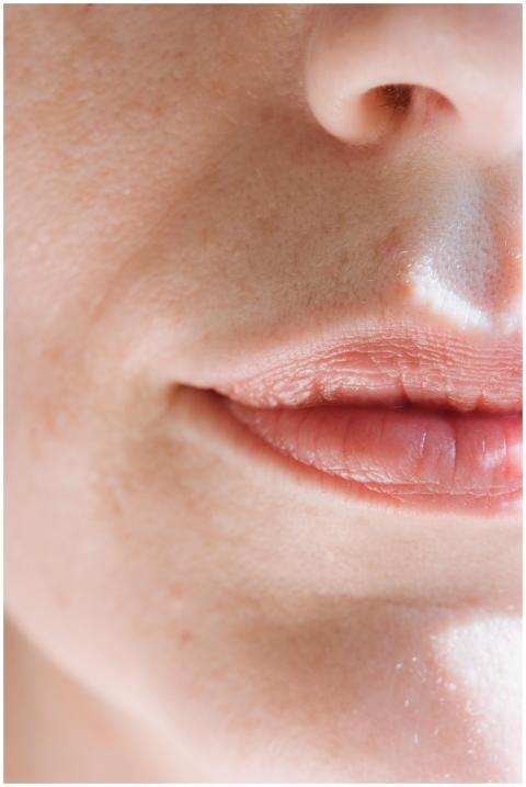 Intimate close-up of feminine lips with soft natur
