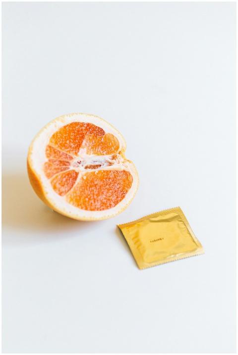 A conceptual image of safe sex using a grapefruit