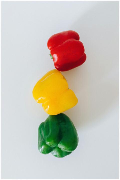 Vivid red, yellow, and green bell peppers arranged