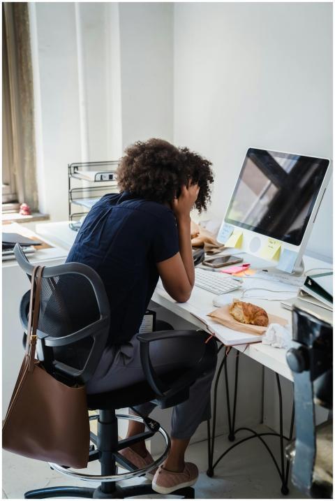 Businesswoman showing stress while working at her