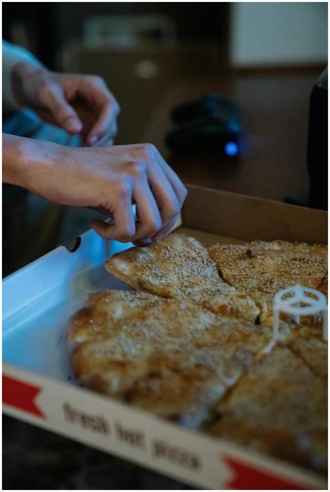 Crop anonymous person taking slice of delicious pi