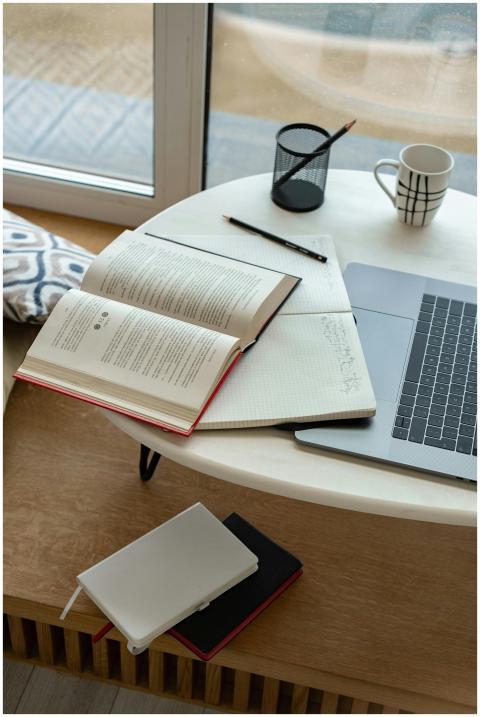 A cozy indoor study setup featuring an open book,