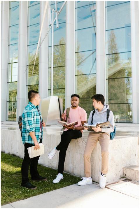 Three college students having a discussion outdoor