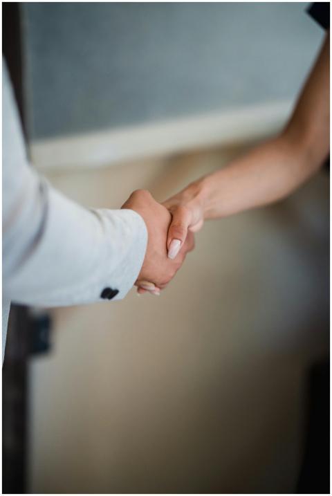 A close-up view of a handshake between two profess