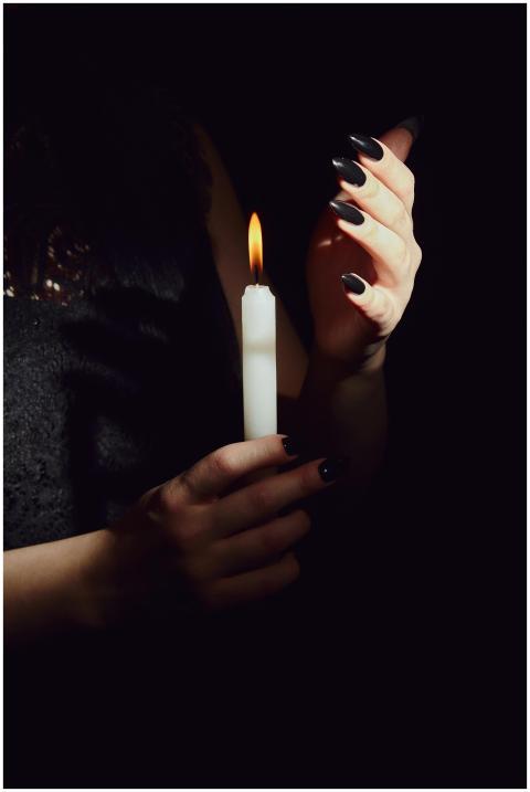 Mystical and serene, a woman holds a candle in the