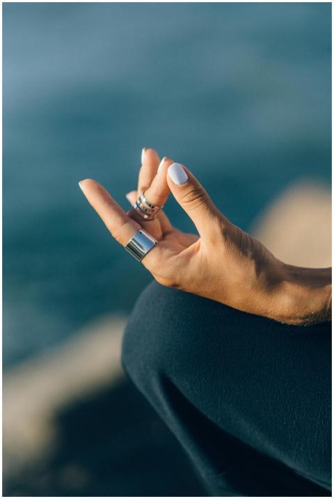 Serene close-up of a hand meditating outdoors with