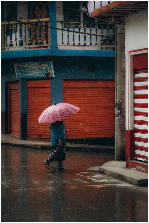 A person with an umbrella walking through a colorf