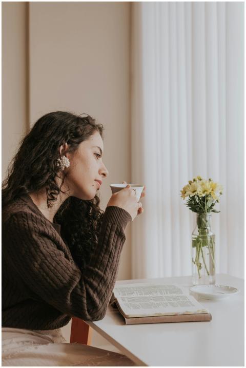 A woman enjoys a quiet moment sipping coffee at ho