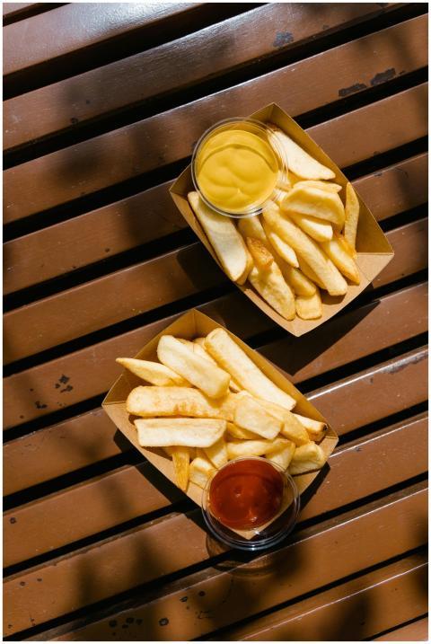 Golden French fries served with ketchup and mustar