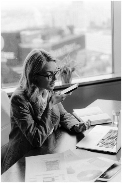 Black and white photo of a woman using voice comma