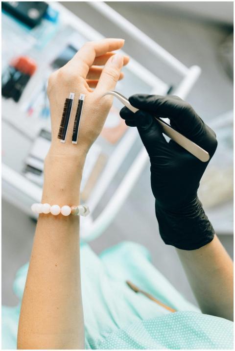 Close-up of a professional applying eyelash extens