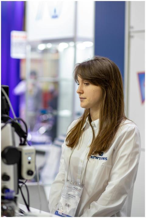 Businesswoman in uniform stands attentively at a t