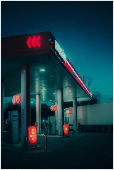 A moody, atmospheric view of a gas station illumin