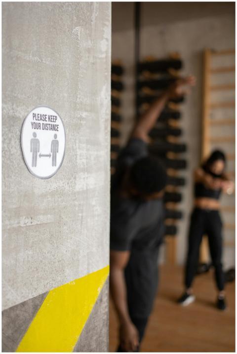 Please Keep Your Distance inscription on sign with