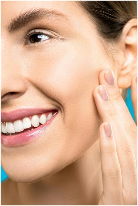 A close-up portrait showing a woman gently touchin