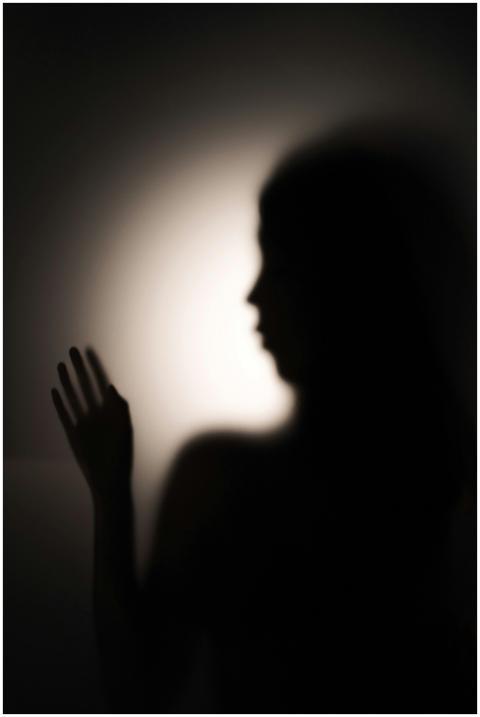 Artistic silhouette of a woman gesturing with hand