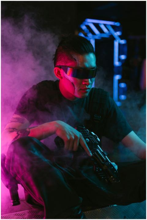 A futuristic person in cyberpunk attire holding a