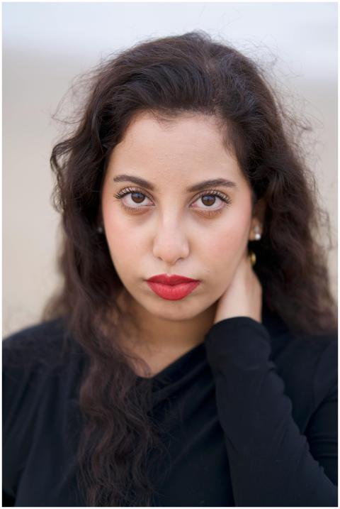 Portrait of a woman with red lipstick and curly ha