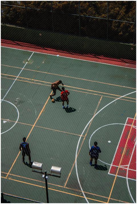 Aerial shot of four men playing basketball on an o