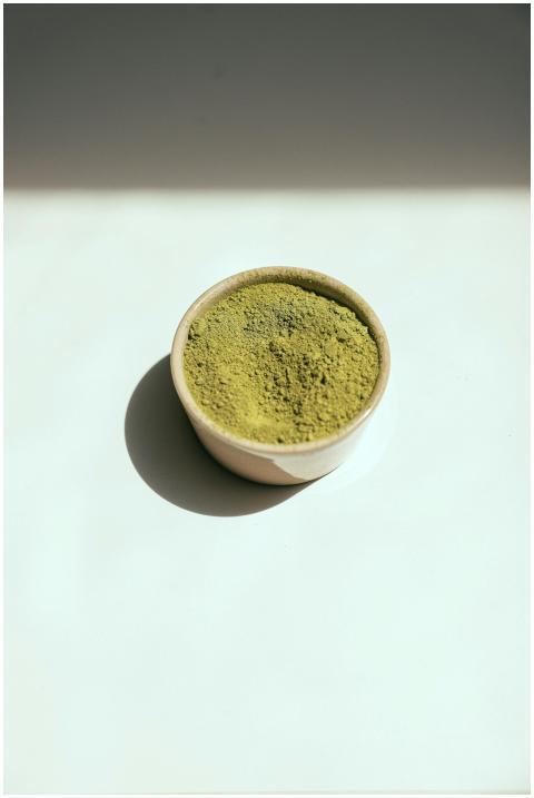 A minimalist ceramic bowl filled with vibrant gree