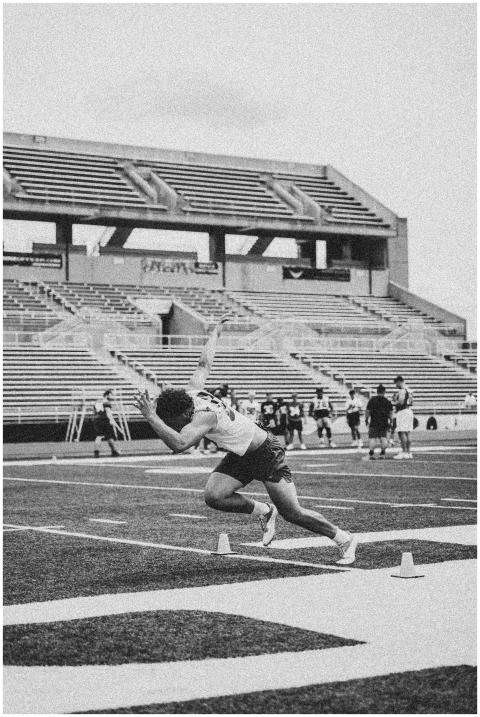 Black and white image of an athlete sprinting on a