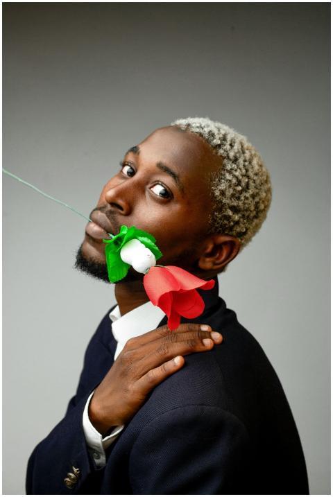 Stylish portrait of a man holding vibrant paper fl