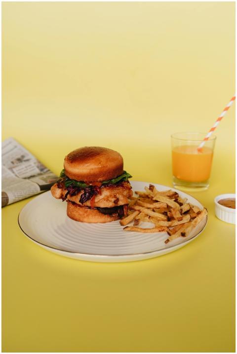 Delicious burger with crispy fries, juice, and new