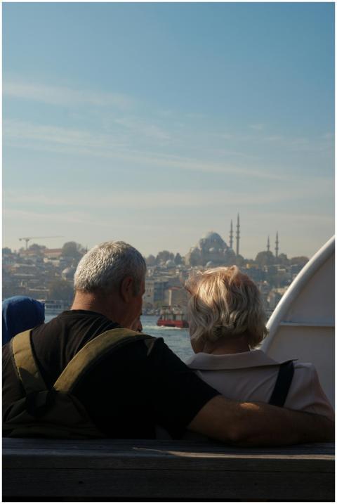 Elderly couple on a ferry with a beautiful view of