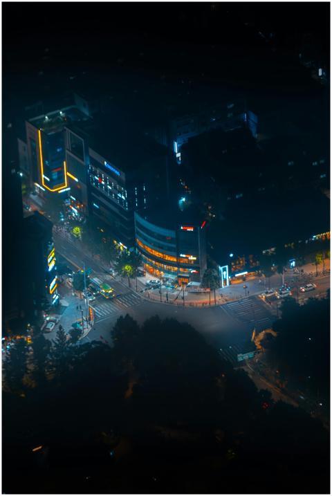 A vibrant aerial night view capturing bustling str