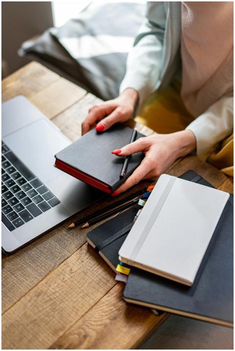 A woman organizing notebooks and journals at a woo