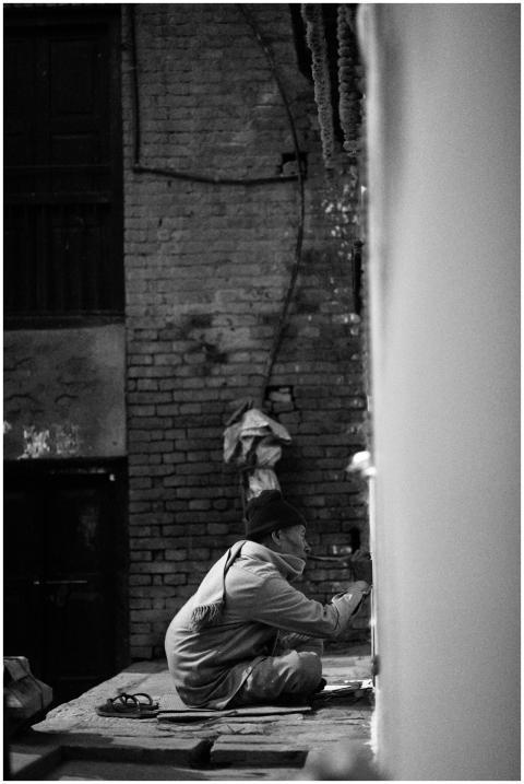 A street artist focuses on creating art on a wall