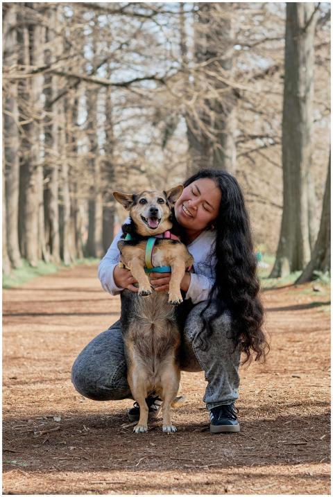 Smiling woman embraces her dog in a sunny Montevid