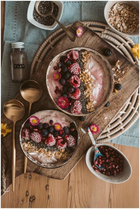 Top view of nutritious smoothie bowls with berries