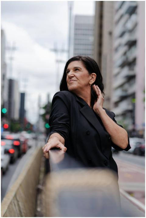 Portrait of an adult woman in black coat, standing