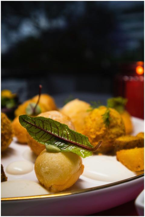 Close-up of gourmet appetizers garnished with fres